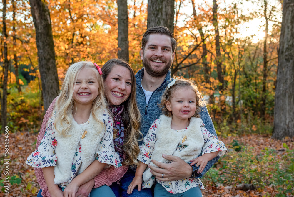 Young couple with two little girls in autumn Young couple with two little girls in autumn