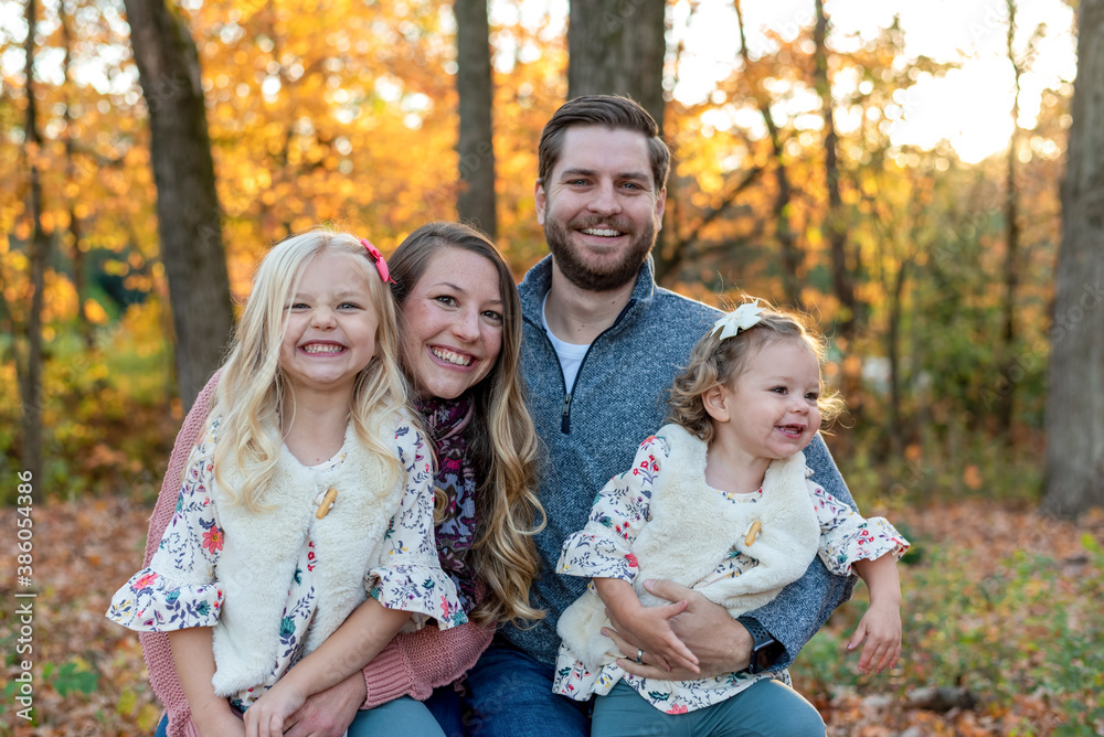 Cute young family with two little girls in autumn Cute young family with two little girls in autumn