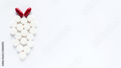 White and Red Pills Isolated on White Background