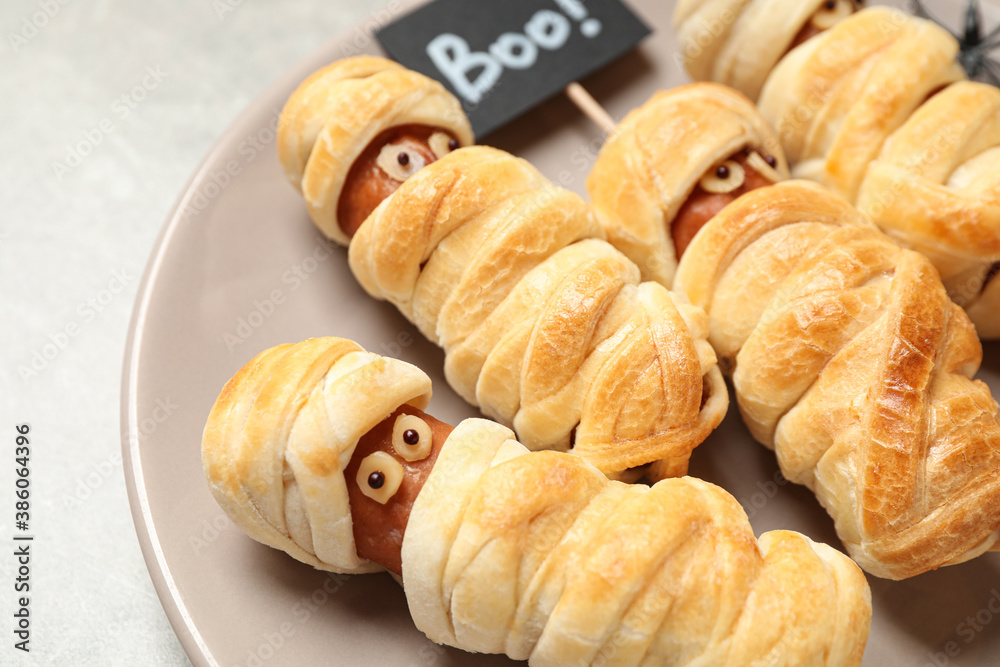 Spooky sausage mummies on table, closeup. Halloween treat