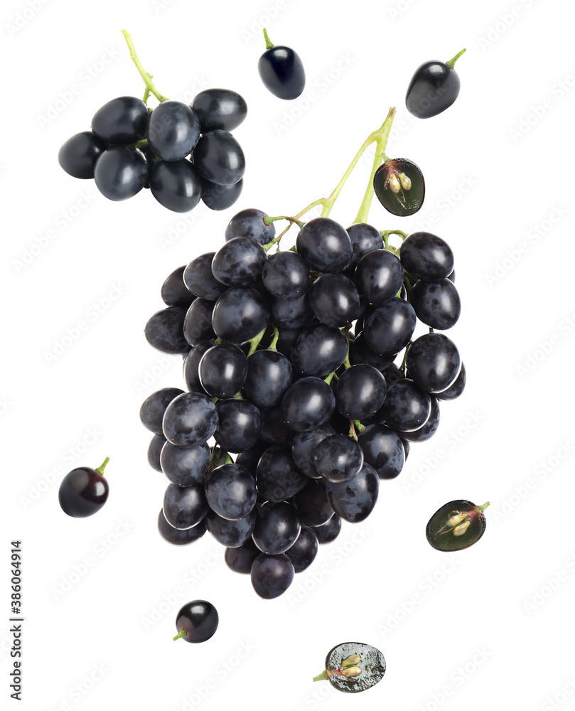 Fototapeta premium Fresh ripe grapes falling on white background