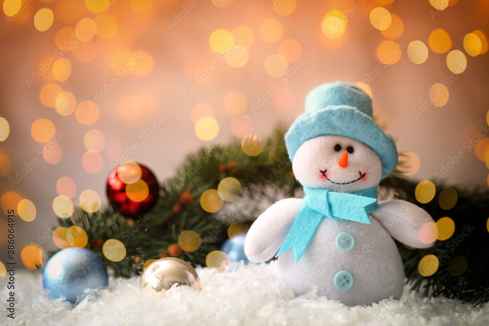 Cute snowman and fir tree branches with Christmas balls on snow, bokeh effect. Space for text Cute snowman and fir tree branches with Christmas balls on snow, bokeh effect. Space for text