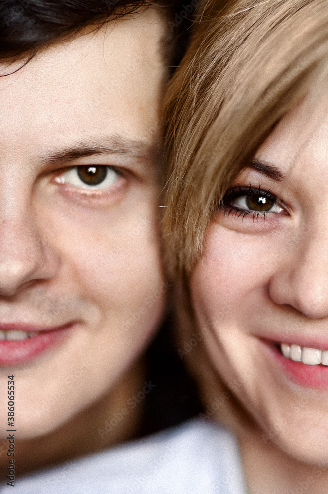 Close-up portrait of a man and a woman who are smiling. Half faces Close-up portrait of a man and a woman who are smiling. Half faces