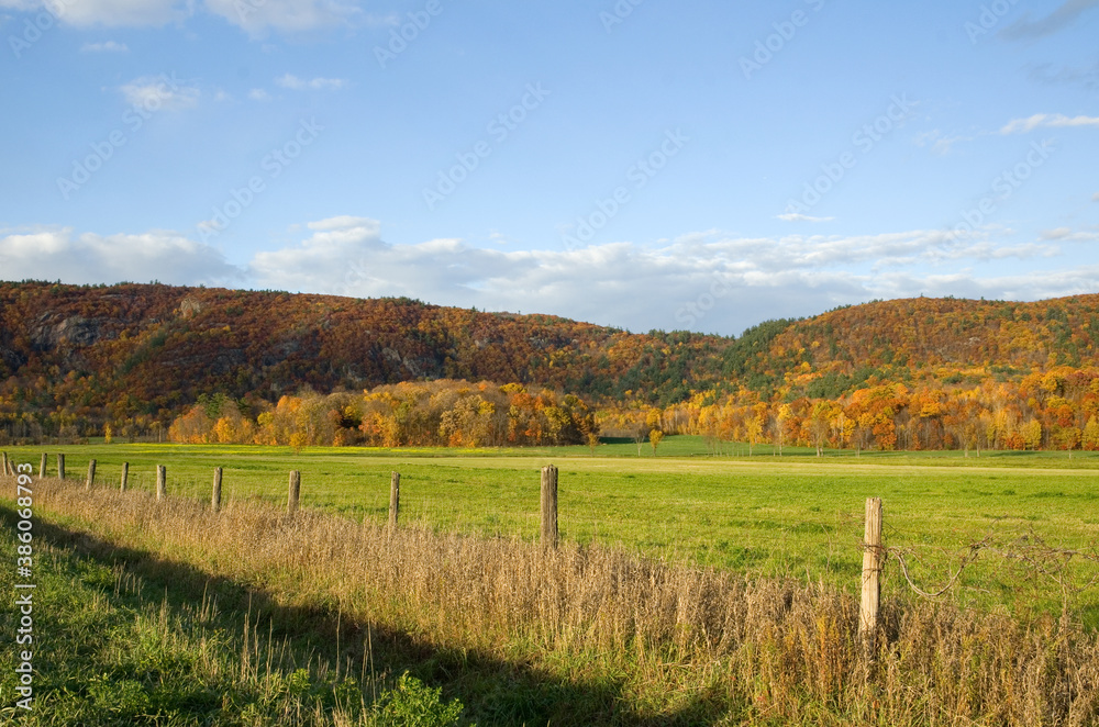 Beautiful Autumn Scene with Farm Fence and Mountains in the Background