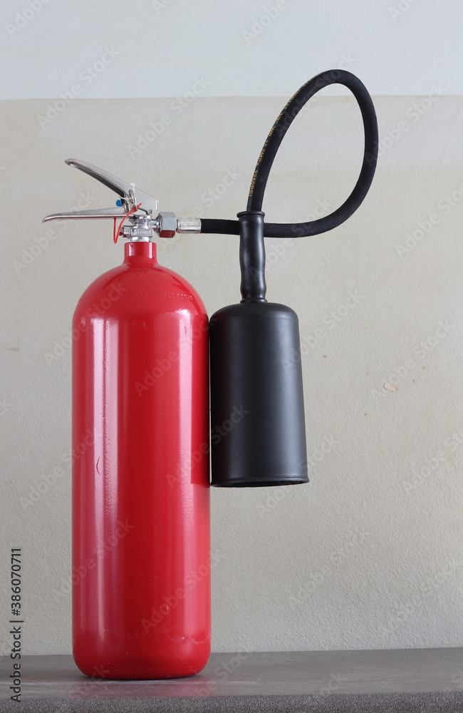 fire extinguisher container on white wall in the building. fire extinguisher container on white wall in the building.