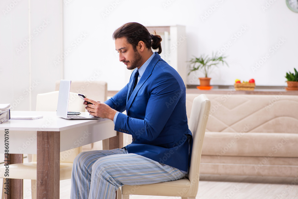 Young male employee working from house in self-isolation concept Young male employee working from house in self-isolation concept