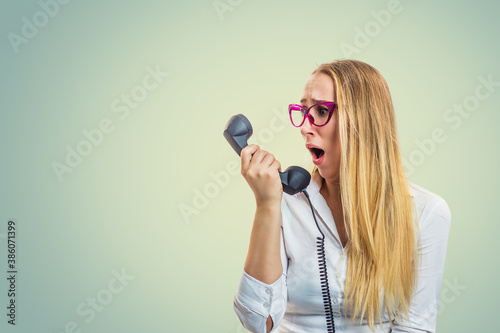 Furious woman looking at phone