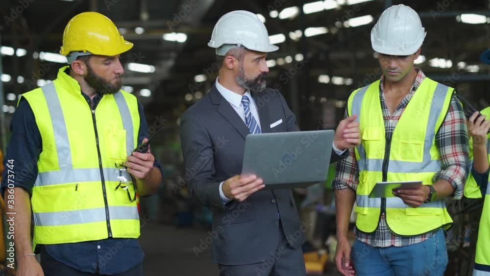 Engineering Worker team working in Heavy Industry Manufacturing Facility. Engineering Worker team working in Heavy Industry Manufacturing Facility.