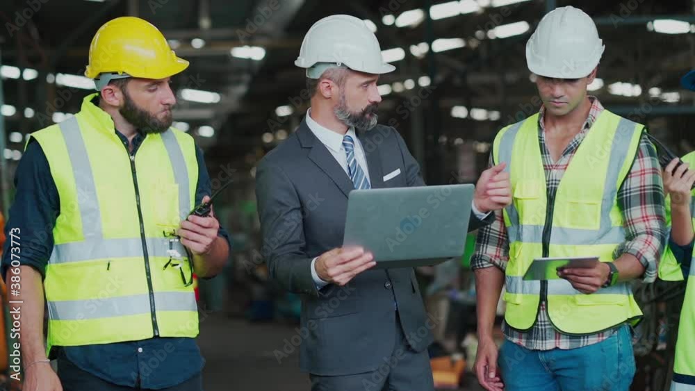 Engineering Worker team working in Heavy Industry Manufacturing Facility. Engineering Worker team working in Heavy Industry Manufacturing Facility.