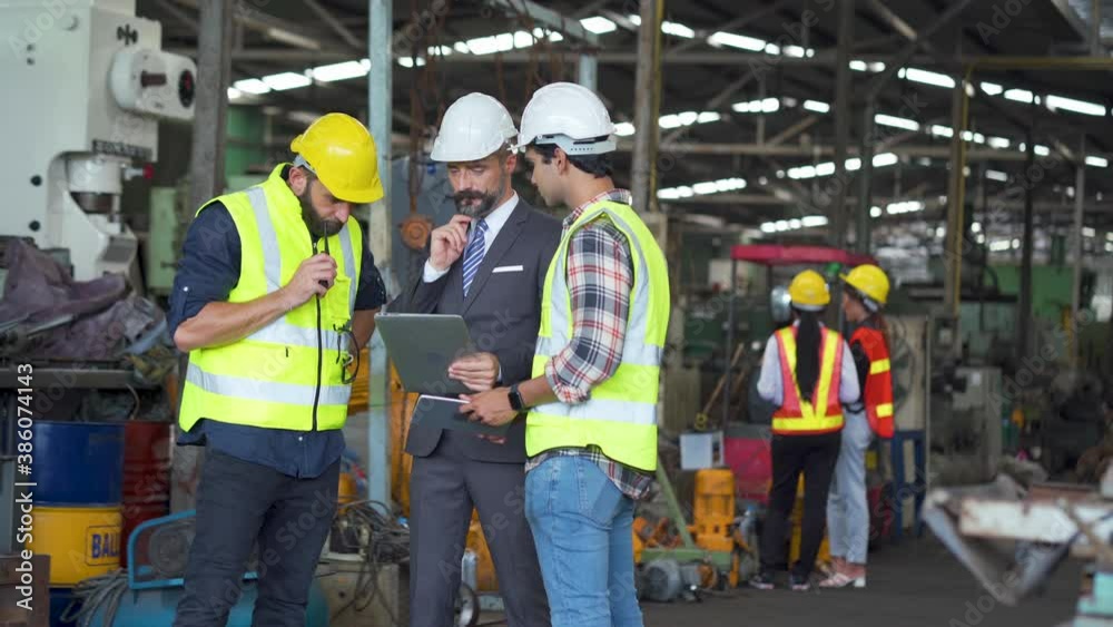 Engineering Worker team working in Heavy Industry Manufacturing Facility. Engineering Worker team working in Heavy Industry Manufacturing Facility.