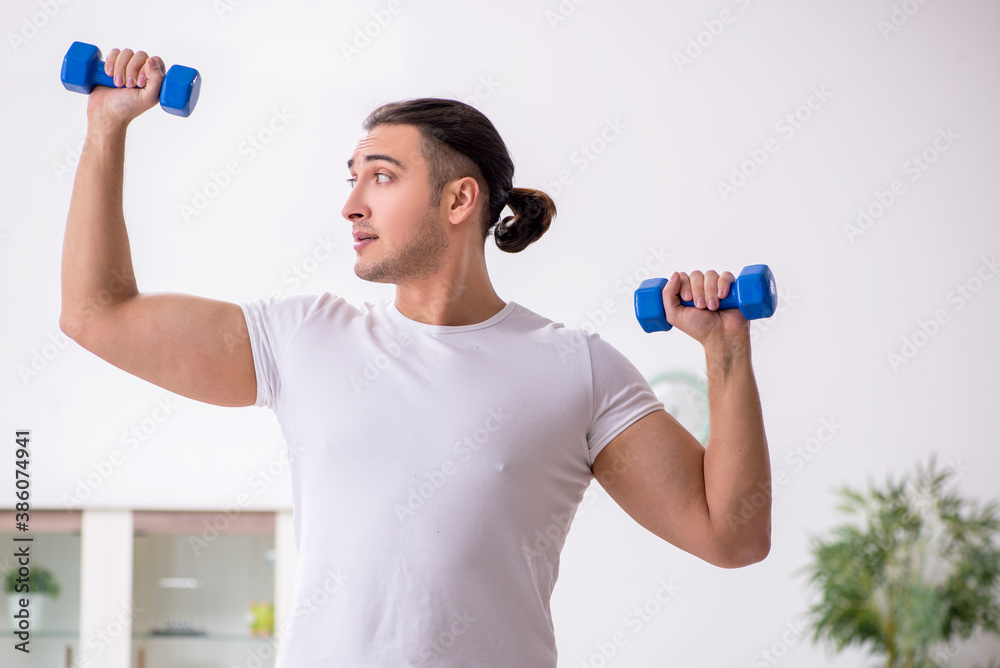 Young male starting day with morning exercises Young male starting day with morning exercises