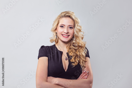 Modern happy blond woman in black dress