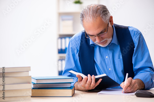 Old male author writing books