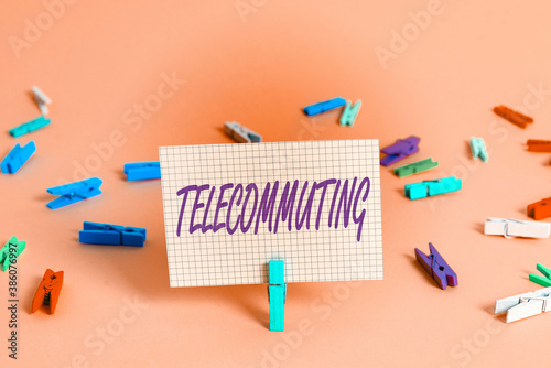 Writing note showing Telecommuting. Business concept for work at home using an electronic linkup with central office Colored crumpled rectangle shaped reminder paper light blue background photo