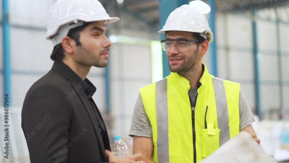 Building designers and foreman are looking at floor plans, layouts, laying out warehouse shelves. Design and decoration of storage buildings Building designers and foreman are looking at floor plans, layouts, laying out warehouse shelves. Design and decoration of storage buildings