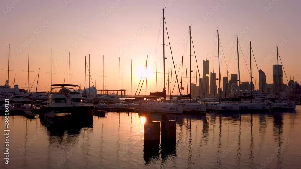 Qingdao, China, October 10, 2020: The dock of the Qingdao Olympic Sailing Center with a city view in the background. Qingdao, China, October 10, 2020: The dock of the Qingdao Olympic Sailing Center with a city view in the background.