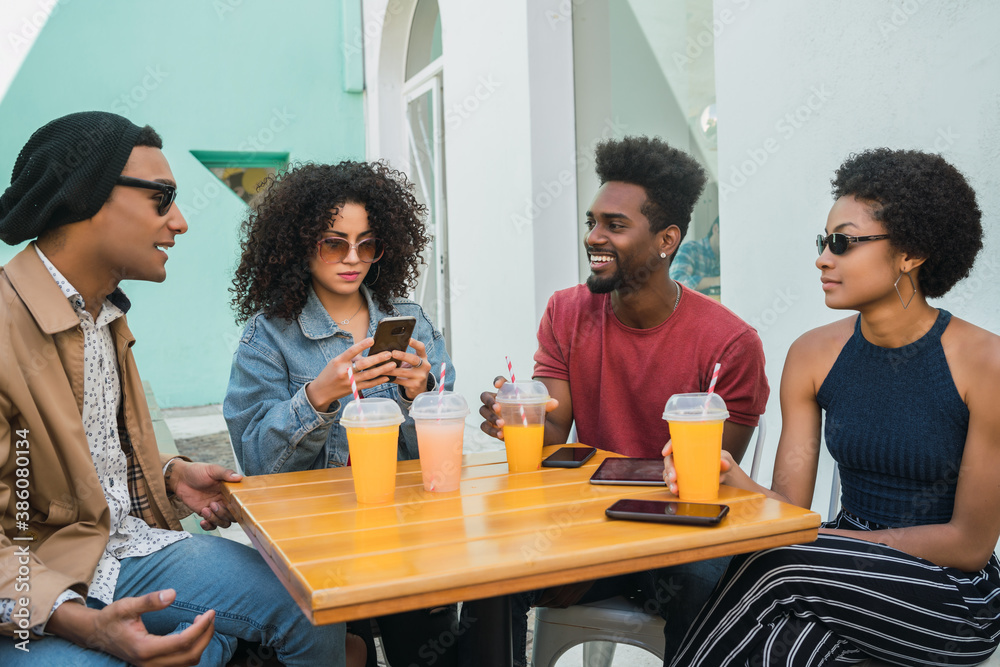Afro friends having fun together while drinking fruit juice. Afro friends having fun together while drinking fruit juice.