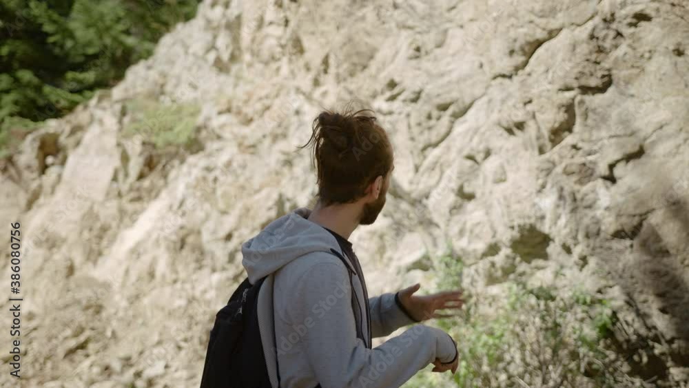 Young backpacker hipster man in forest is being disturbed by mosquito or bees Young backpacker hipster man in forest is being disturbed by mosquito or bees