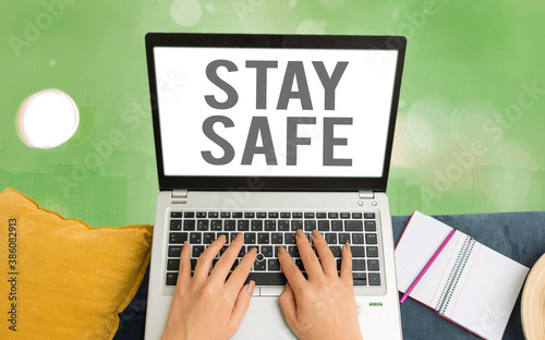 Word writing text Stay Safe. Business photo showcasing secure from threat of danger, harm or place to keep articles Modern gadgets with white display screen under colorful bokeh background photo