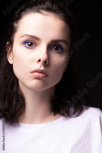 woman with blue makeup on face 