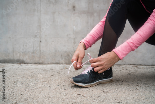 Athletic woman tying her shoelaces.