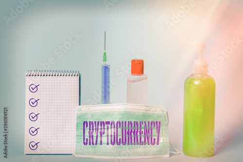 Writing note showing Cryptocurrency. Business concept for form of currency that exists digitally has no central issuing Set of medical equipment with notepad for health condition assessment photo