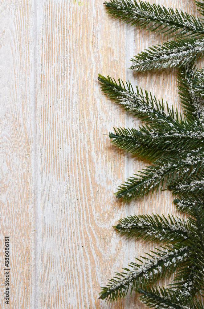 Winter background, pine or spruce branches on a white wooden background top view of flat lay, greeting card with copy space text Winter background, pine or spruce branches on a white wooden background top view of flat lay, greeting card with copy space text