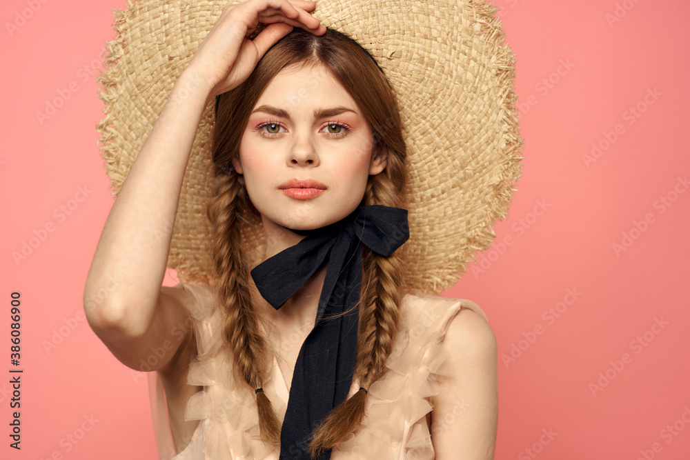 Romantic girl with pigtails and in a straw hat smile romance pink background Copy Space Romantic girl with pigtails and in a straw hat smile romance pink background Copy Space