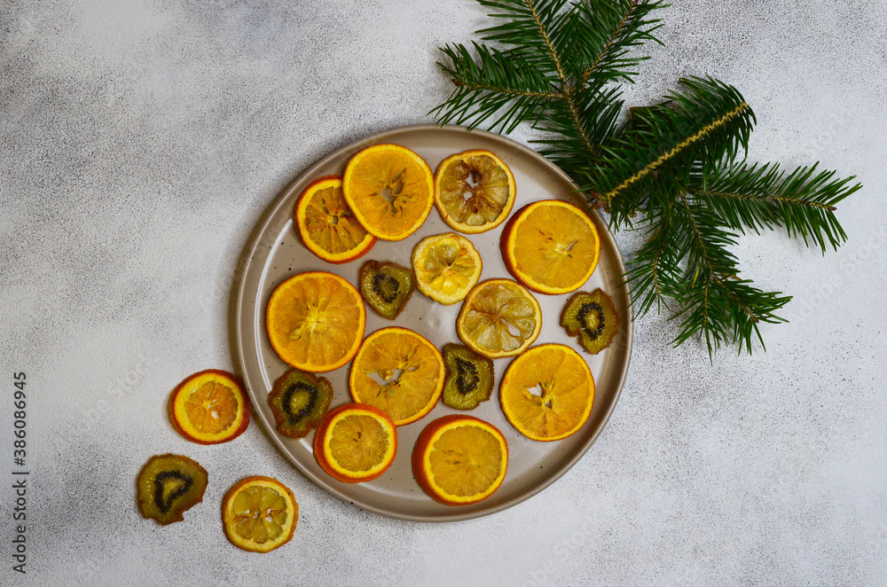 christmas food concept, fla tlay copy space text, dried oranges, fir branches on grey concrete background