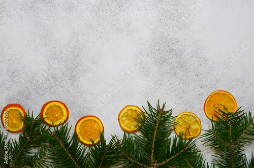 christmas food concept, fla tlay copy space text, dried oranges, fir branches on grey concrete background photo