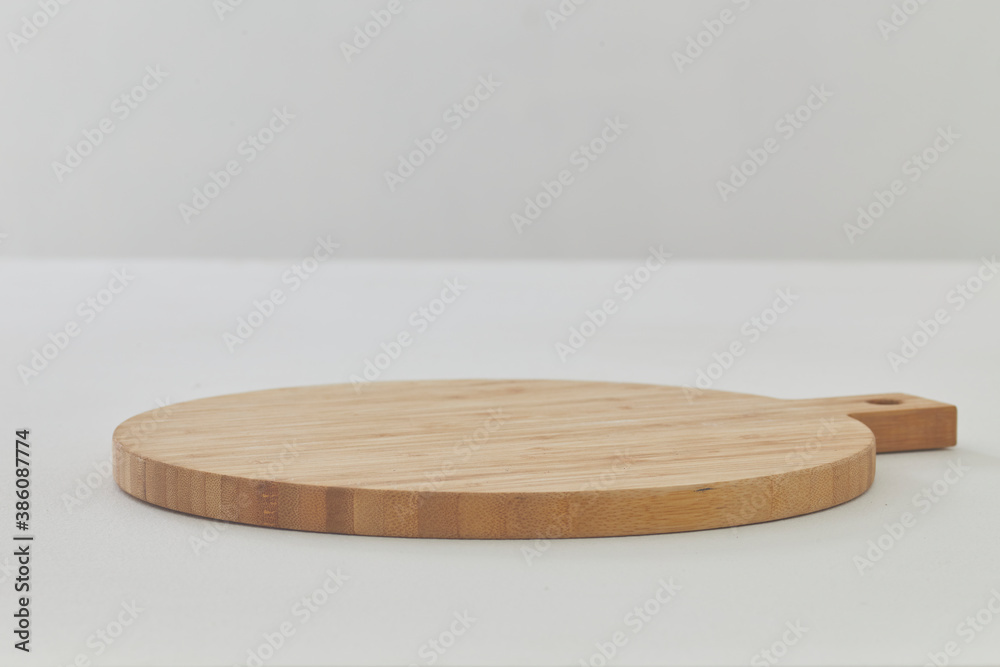 Empty cutting board on a white wooden table Empty cutting board on a white wooden table