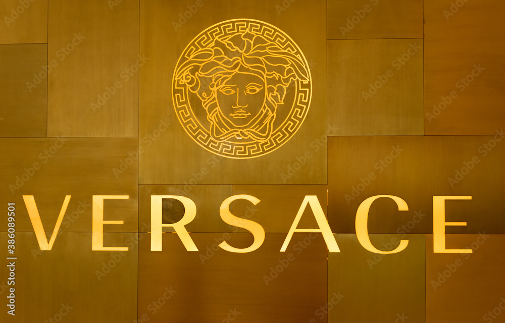 tanker Propovijedati Nažalost  golden Versace Logo on wall of shop in Bangkok. It is an Italian fashion  brand company founded by Gianni Versace in 1978 Stock Photo | Adobe Stock