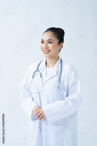 Woman doctor in white uniform standing with crossed arms. isolated female portrait.
