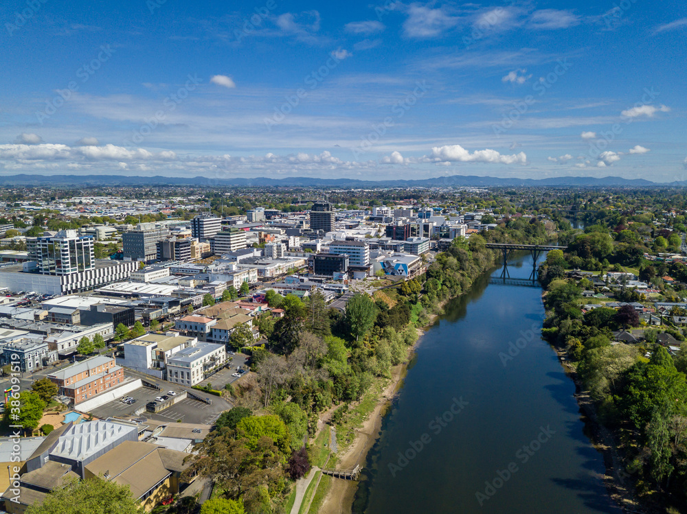 Obraz premium Aerial drone view looking towards the CBD as the Waikato River cuts through the city of Hamilton, in the Waikato region of New Zealand