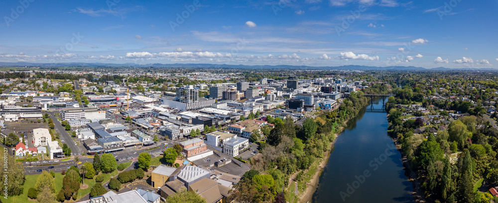 Aerial drone panoramic view looking towards the CBD as the Waikato River cuts through the city of Hamilton, in the Waikato region of New Zealand
