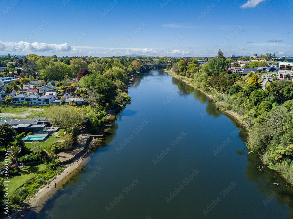 Aerial drone view looking at Victoria Bridge over the Waikato River as it cuts through the city of Hamilton, in the Waikato region of New Zealand