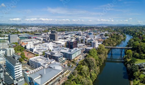 Aerial drone view looking at Claudelands Bridge over the Waikato River as it cuts through the city of Hamilton, in the Waikato region of New Zealand