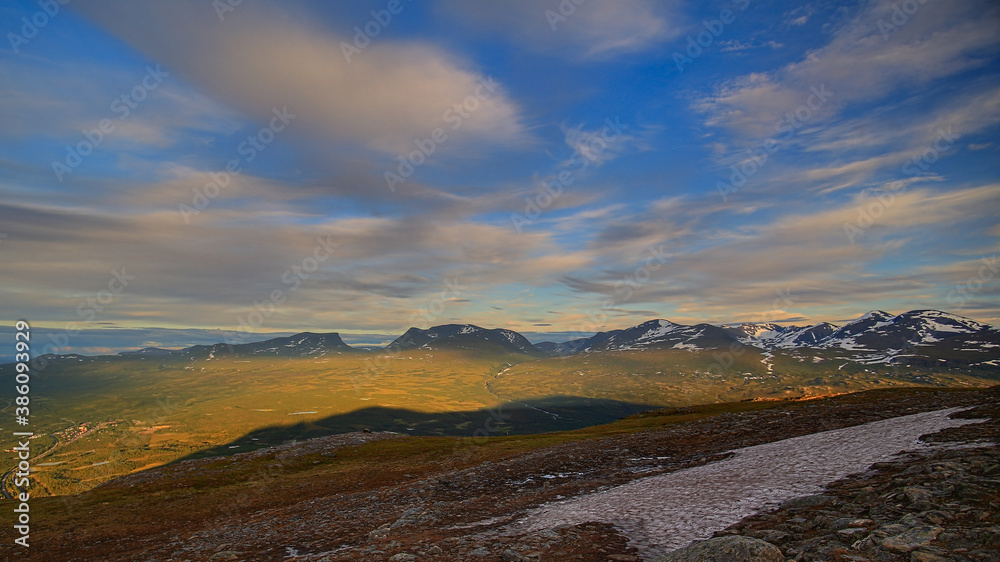In summer nights here on Mount Nuolja, the mountain casts a shadow on Abisko valley