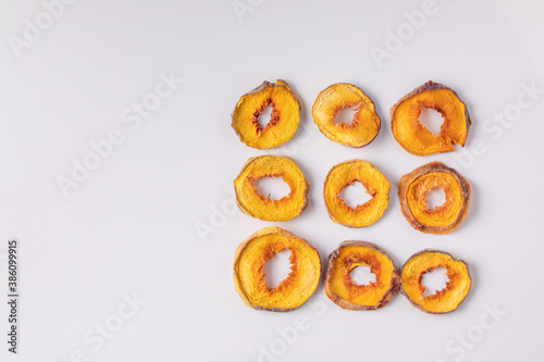 slices of dried peach on a white background. dried fruits. eco. top view.