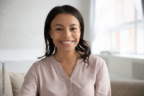 Free Download Profile picture of smiling African American young woman renter or tenant look at camera at home. Headshot portrait of happy biracial female employee talk on video call, have webcam meeting online. - GFXLoad