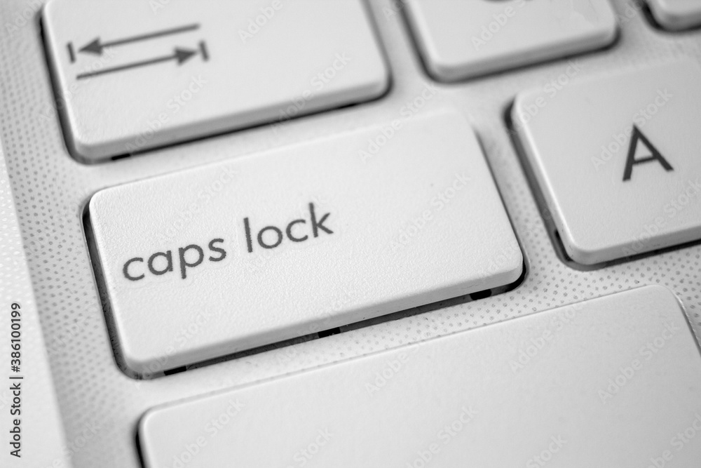 Caps Lock key on laptop close up. International Caps Lock Day