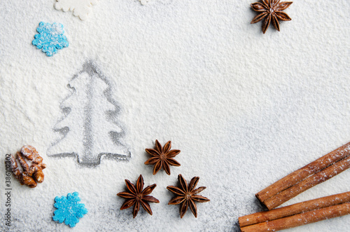 Obraz na płótnie Christmas kitchen background made of flour, cinnamon sticks, anise, cookie cutter and sugar sprinkles w salonie