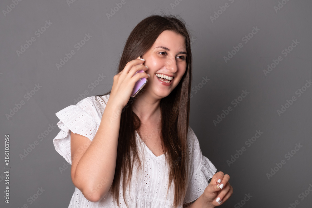 Happy young woman emotionally talking on a mobile phone. Happy young woman emotionally talking on a mobile phone.