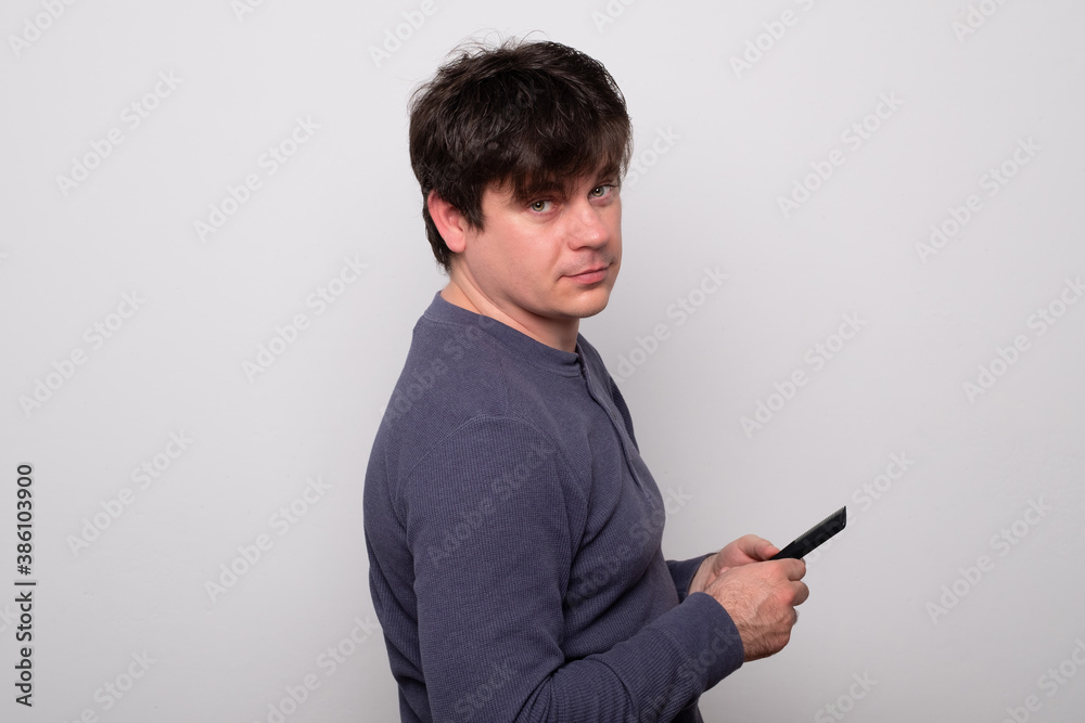 Handsome man with wet hair is combing. Young man in pajamas combing his hair after a shower. Handsome man with wet hair is combing. Young man in pajamas combing his hair after a shower.