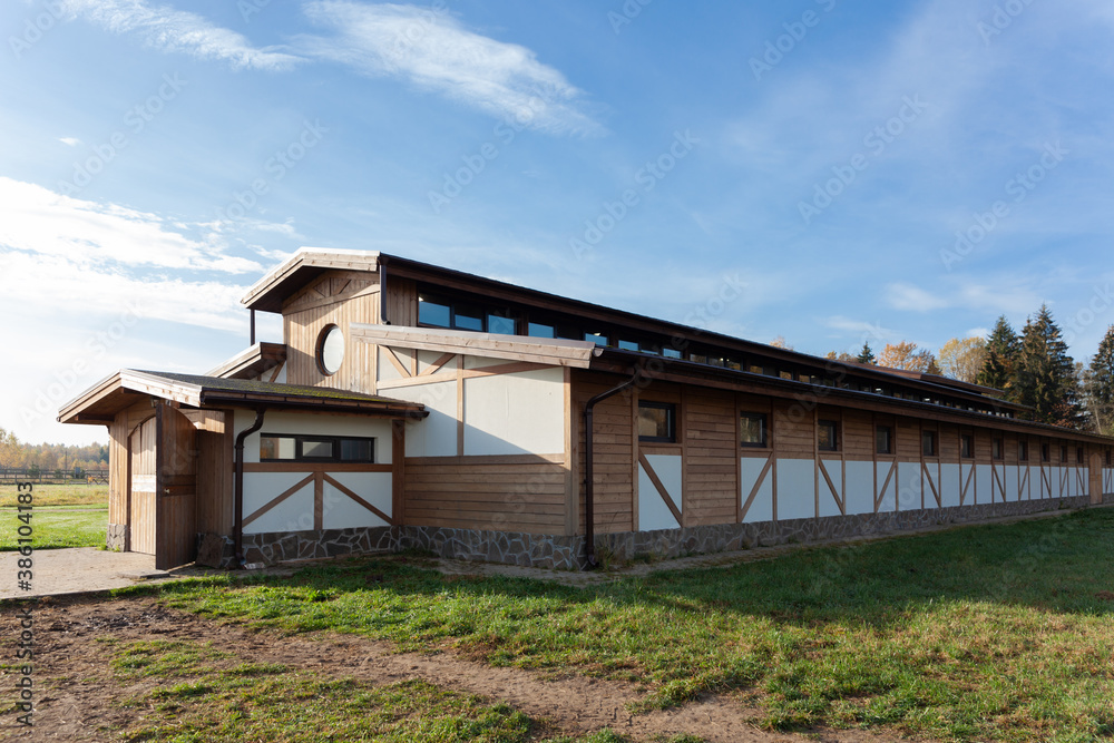 large stable on the farm. outside view on a summer sunny day