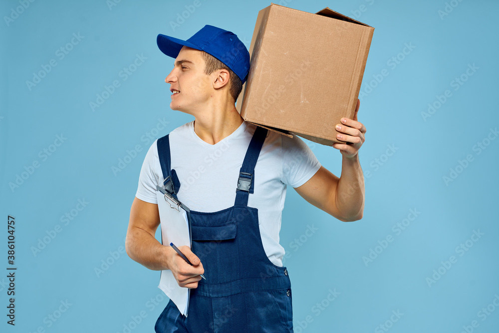 Man worker with cardboard box delivery loader lifestyle blue background Man worker with cardboard box delivery loader lifestyle blue background