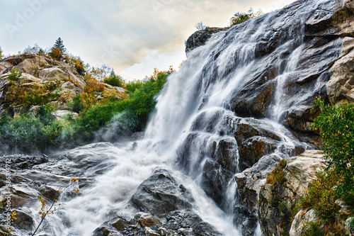 Mountain river. Waterfall view. Wild river stream rocks flowing. River rocks view.