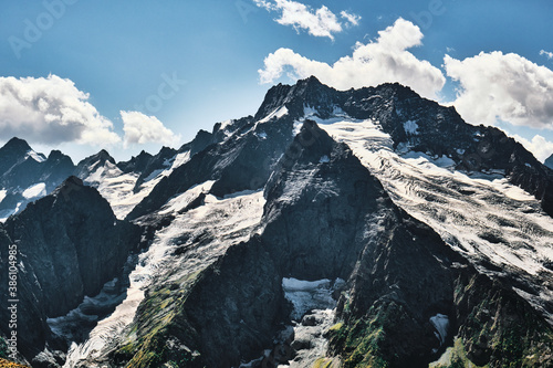 Panorama of high mountains landscape with clouds on sky. Rocks.