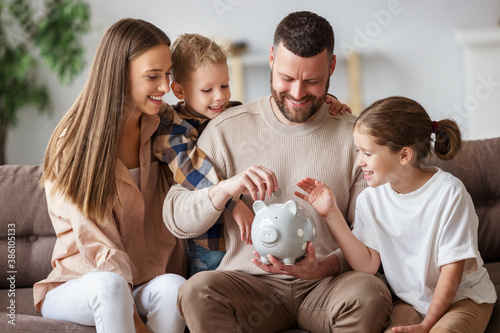 Slika na platnu Happy family saving money together.