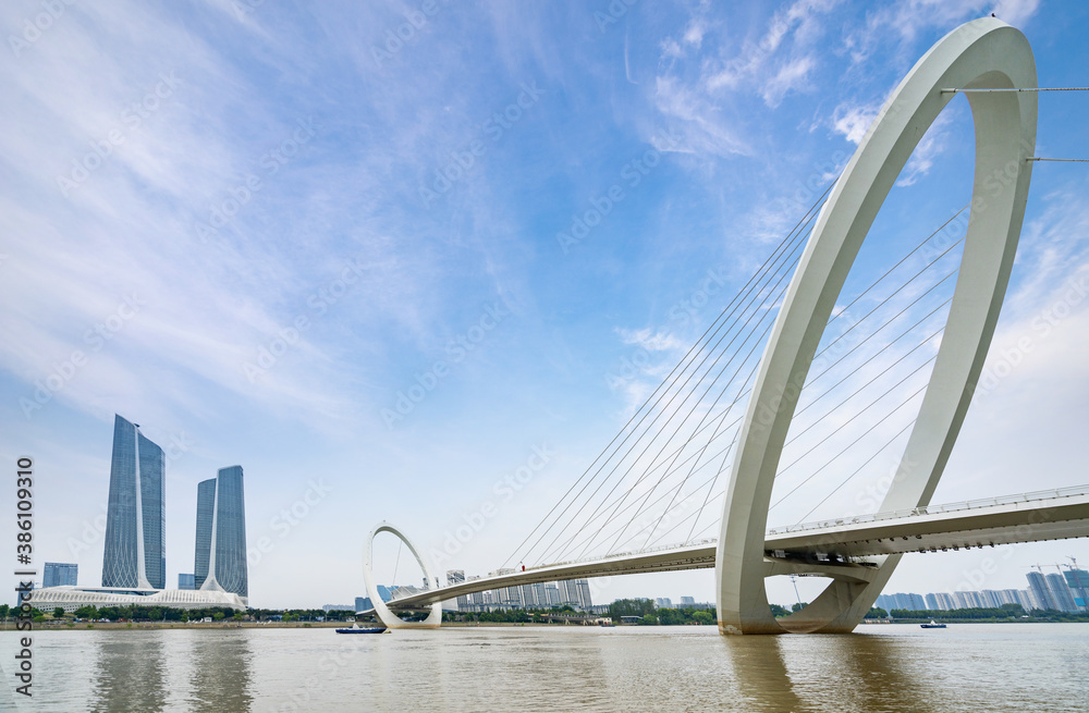 Obraz premium Eye of Nanjing Pedestrian Bridge and urban skyline in Nanjing, China